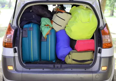 car and plenty of luggage and suitcases when leaving for family summer holidays